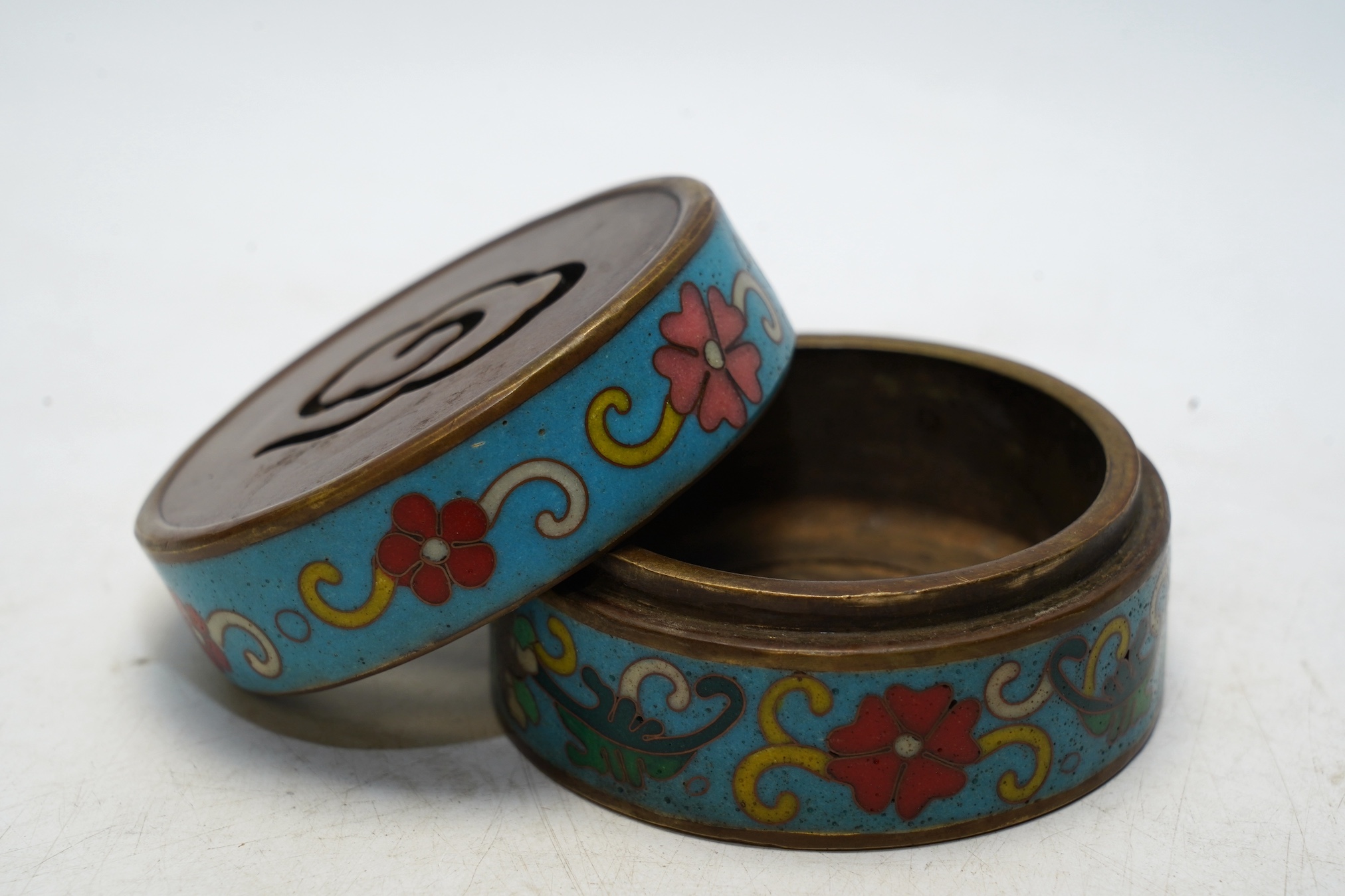 A heavy Chinese cloisonné incense box enamelled with flowers, apocryphal Qianlong mark 8cm in diameter. Condition - fair